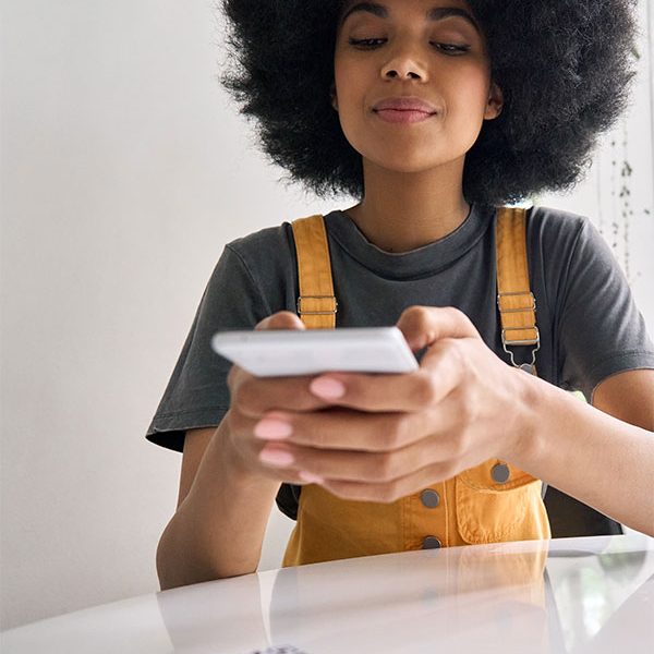 Blog featured image:Contactless Integrated Payments QR Code Solutions. image of a woman making a payment on her device