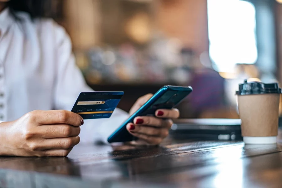 Blog featured image: Year in Review. lady hands holding a card and device making an online payment